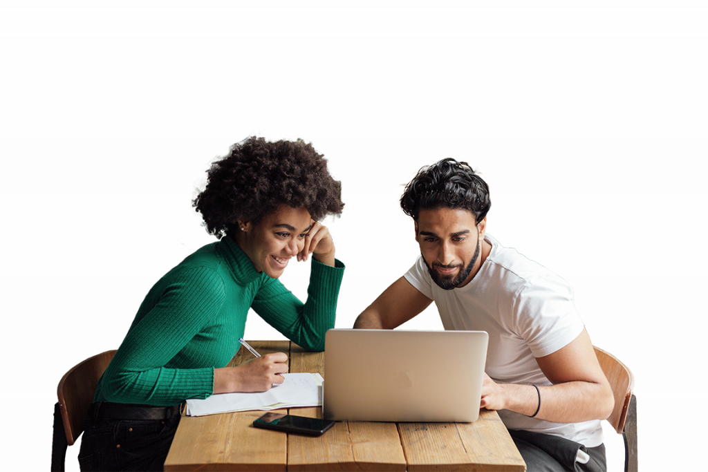 Happy couple sitting at a desk doing research on a laptop